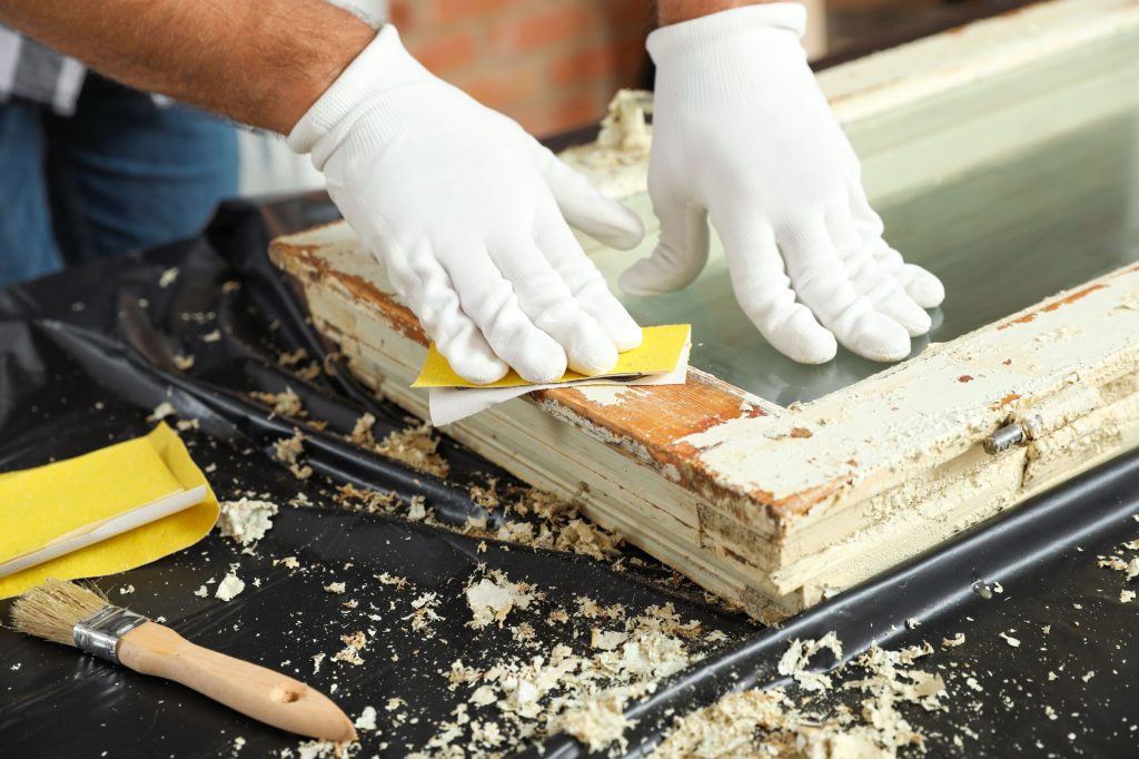 man repairing old damaged window at table indoors 2026 03 26 23 59 10 utc1